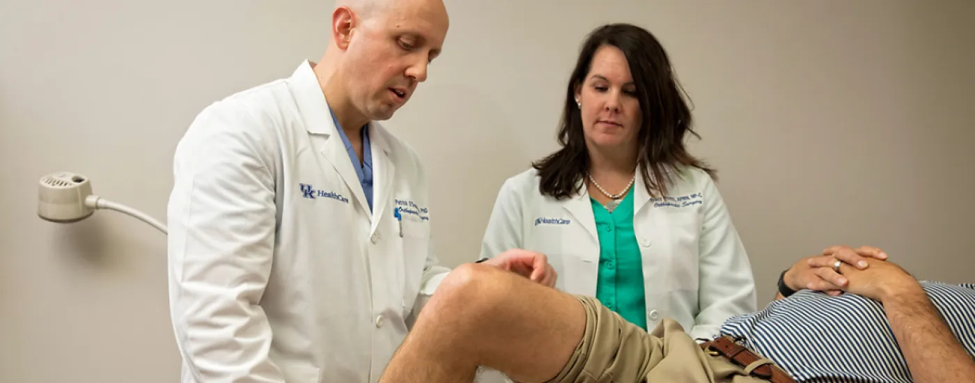 Dr. Patrick O'Donnell, and nurse practitioner Tracy Profitt examining a patient's knee