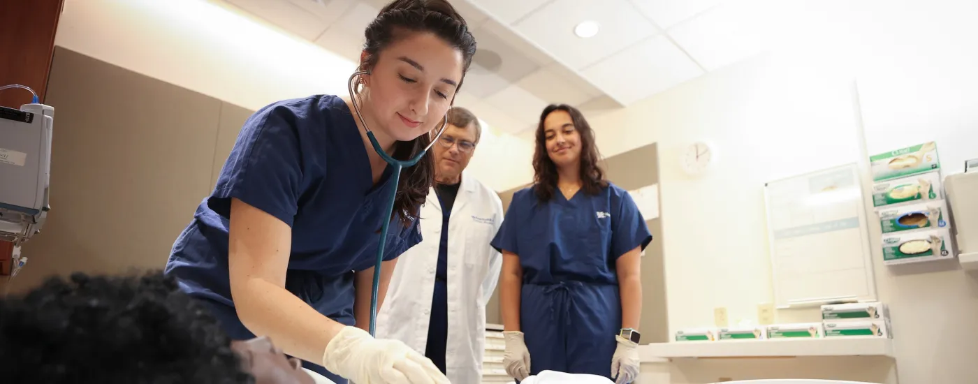 students in a simulation patient room