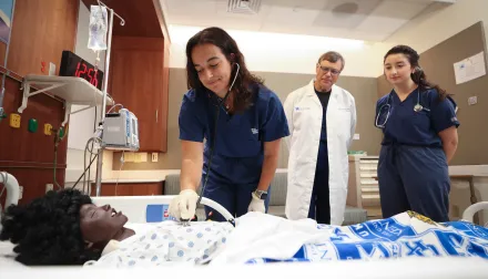 students in a simulation patient room